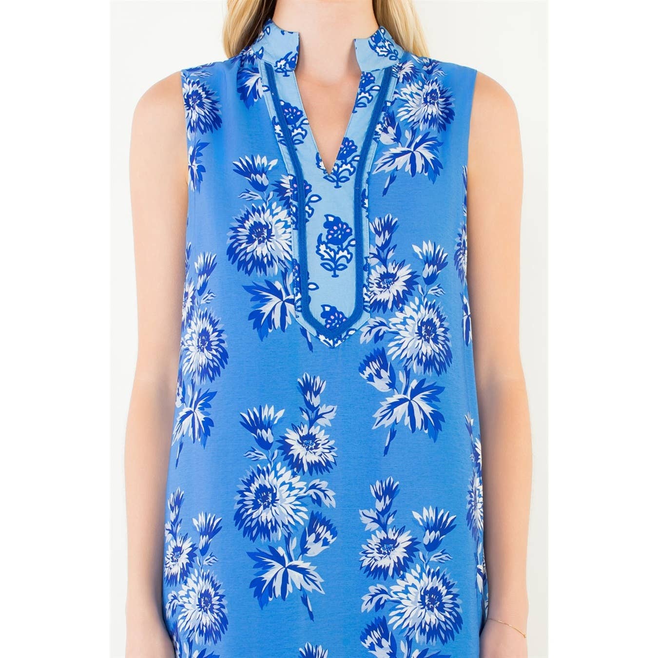 Blue floral sleeveless top on a white background