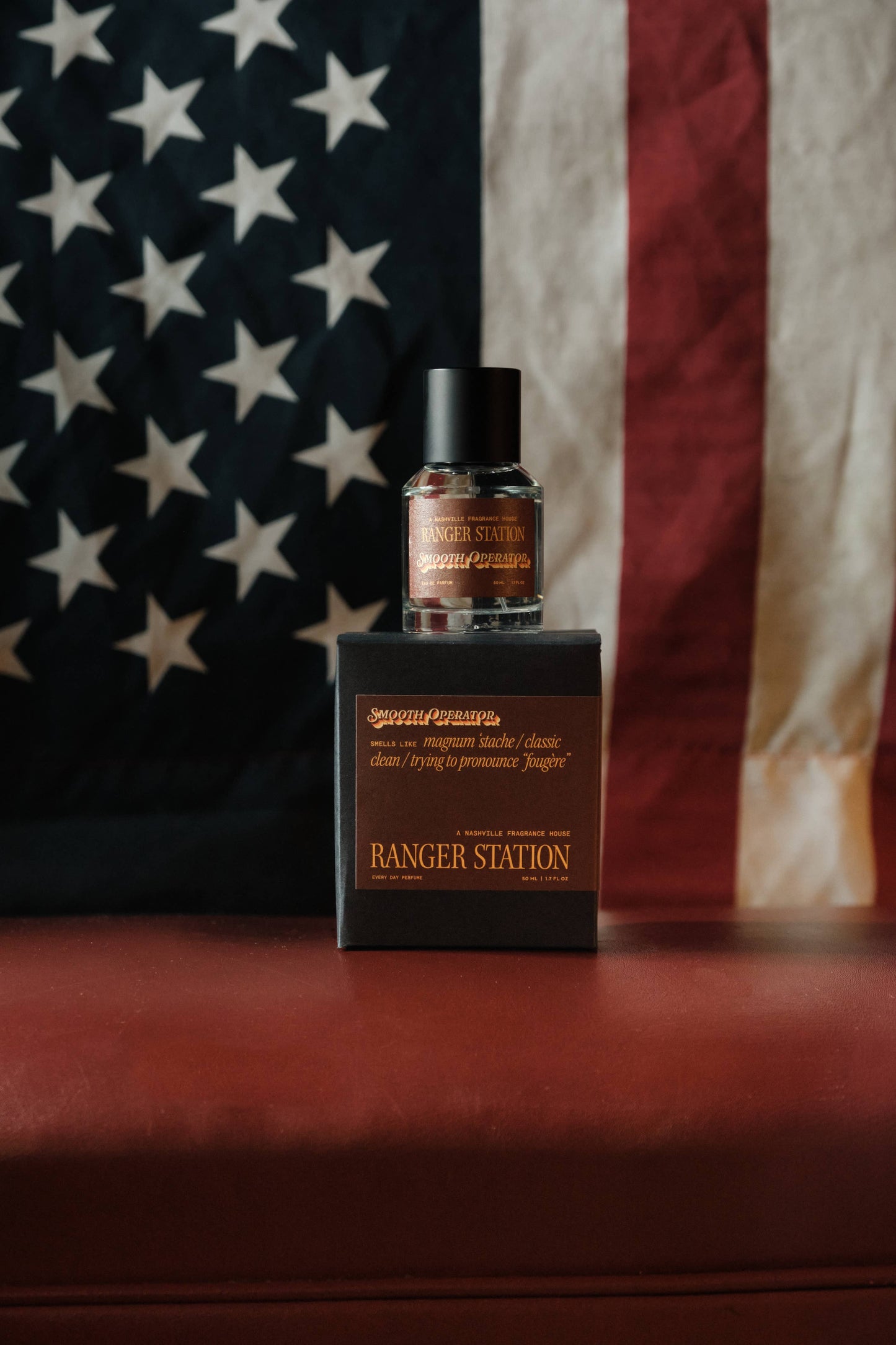 Bottle and box of 'Ranger Station' product with an American flag in the background