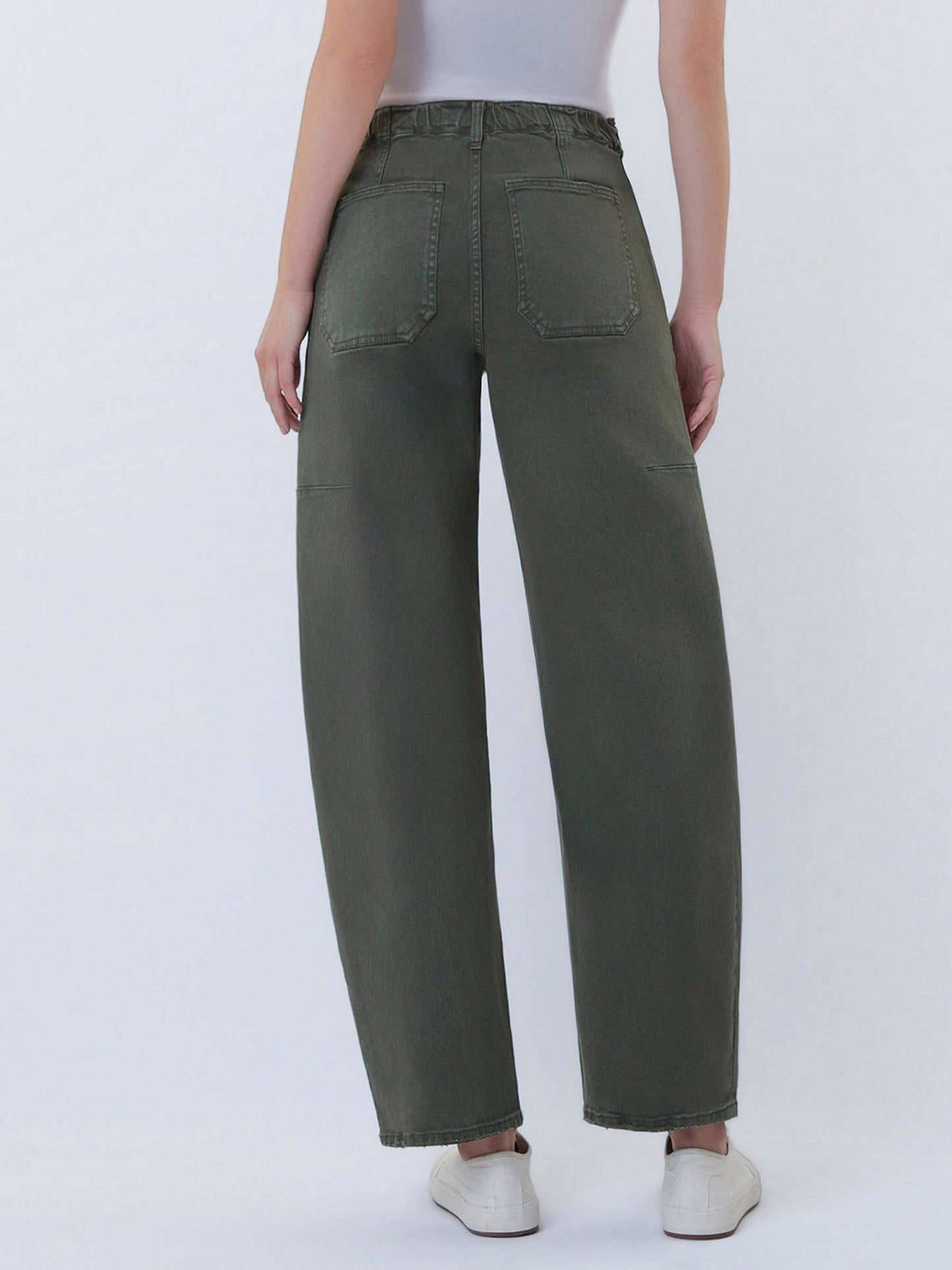 Person wearing olive green pants on a white background