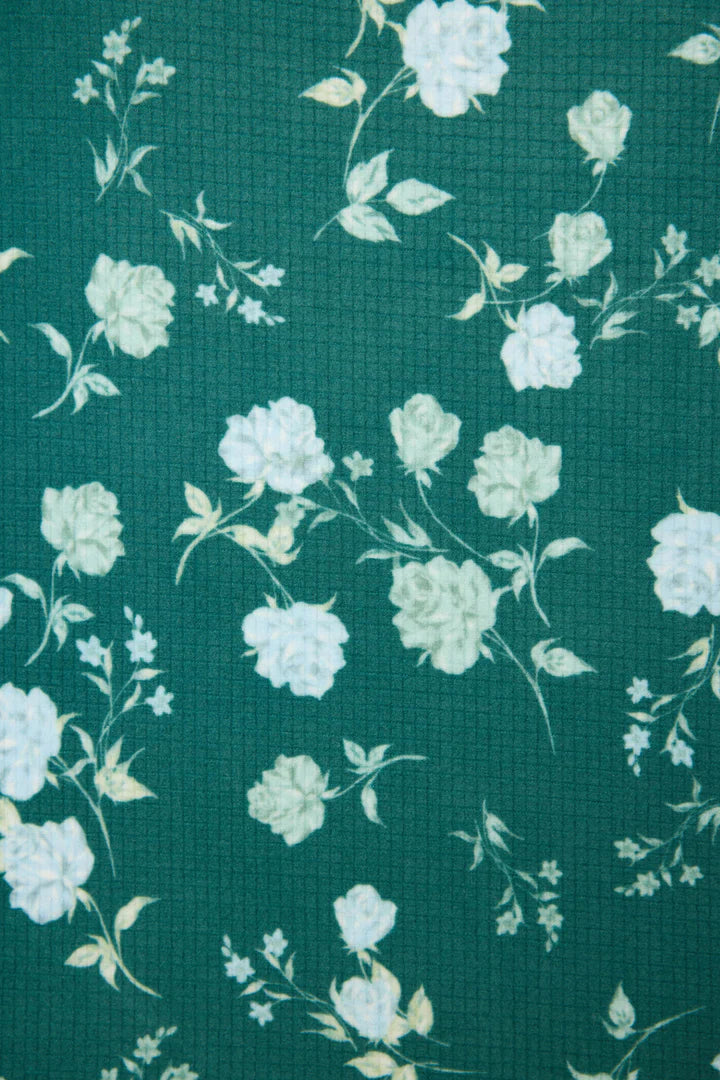 Floral pattern with white flowers on a teal background